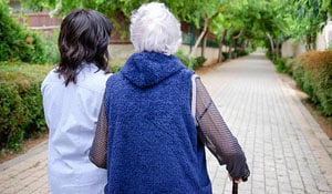 In-Home Health Caretaker Helping Senior Citizen Go For A Walk In Katy, Tx